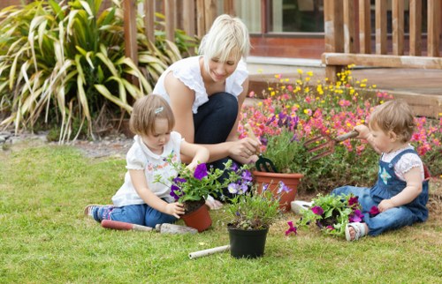 Gardening team with tools at front of property